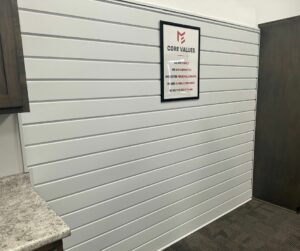 Textured Alamo metal siding featured on an interior wall in a Metal Exteriors conference room.