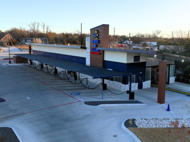 Wide view of Kwik N Clean car wash building featuring Reveal Plank metal siding