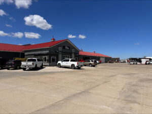 Vehicles park in the Metal Exteriors parking lot just outside the company's main door.