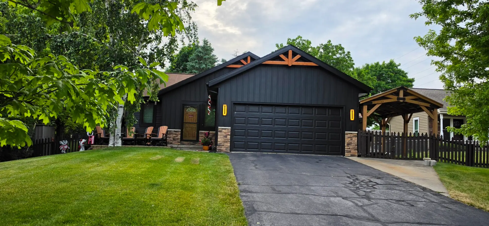 Black metal batten siding installed on a remodeled Wisconsin garage exterior