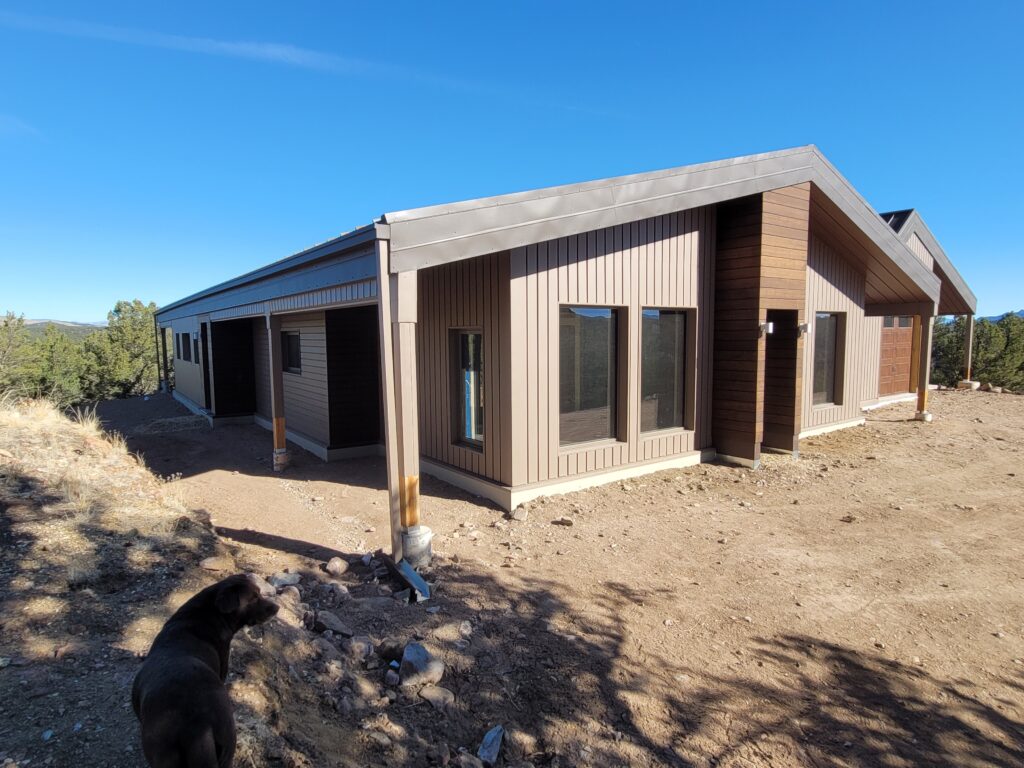 Custom modern home in Westcliffe, CO with textured Buckskin metal siding and Mocha Brown batten accents.